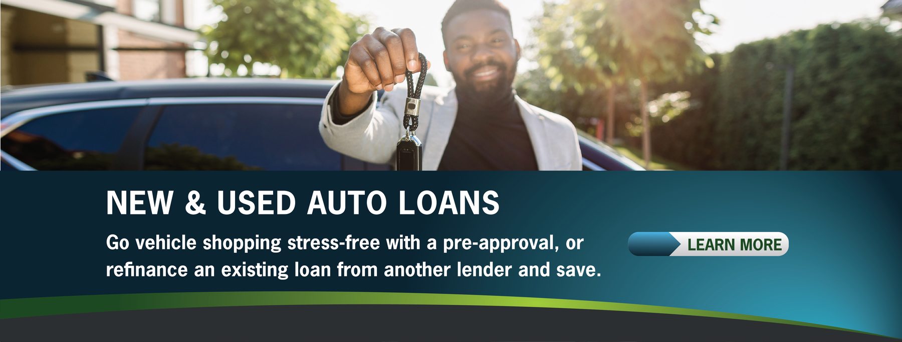 A person smiling, holding car keys, stands by a vehicle. Text promotes new and used auto loans, emphasizing stress-free shopping.