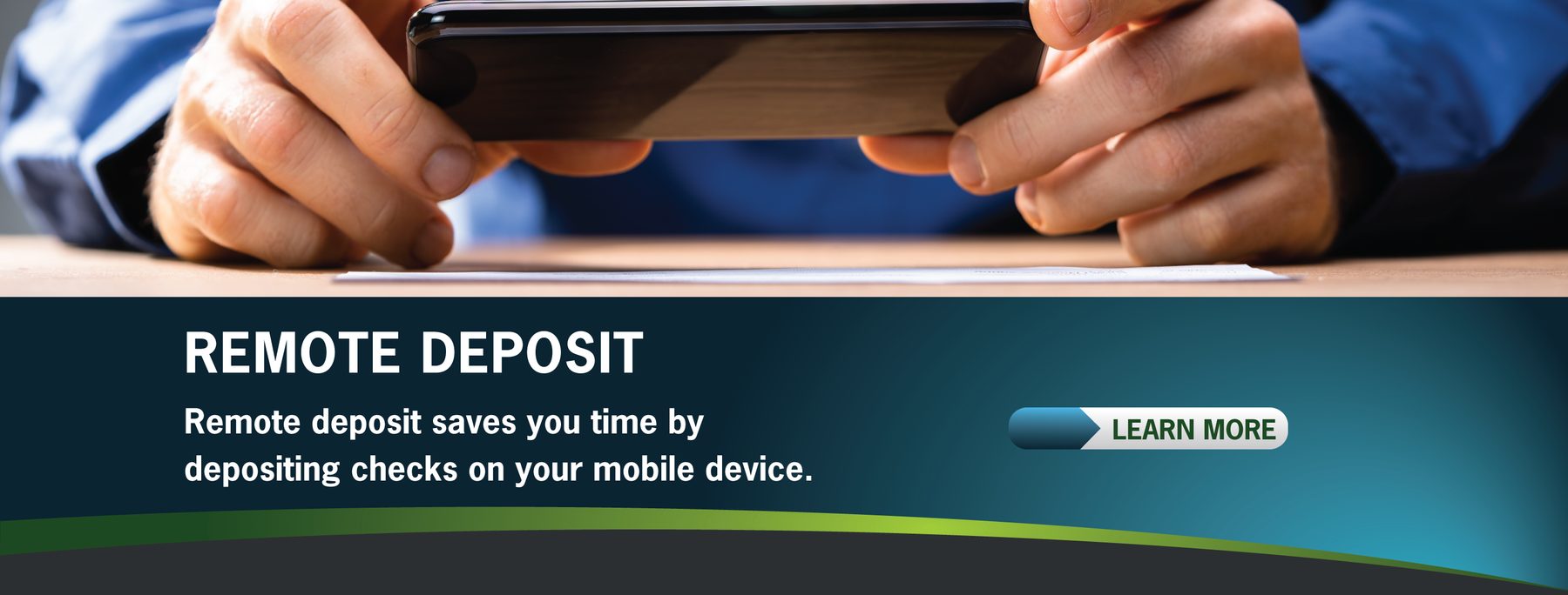 A person holds a smartphone over a check for remote deposit. The text promotes mobile check depositing, featuring a "Learn More" button.
